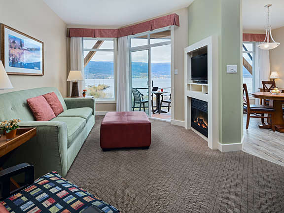 Living and dining area of a two-bedroom suite at Summerland Waterfront Resort with lake views and private balcony